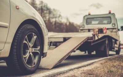 Loading broken car on a tow truck on a roadside.jpg