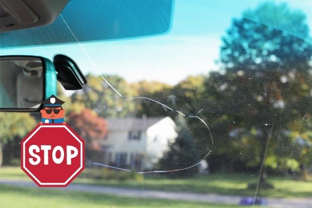 Policeman stops windshield crack from spreading