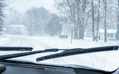 Car is driving during heavy snow, windshield wipers are turned on